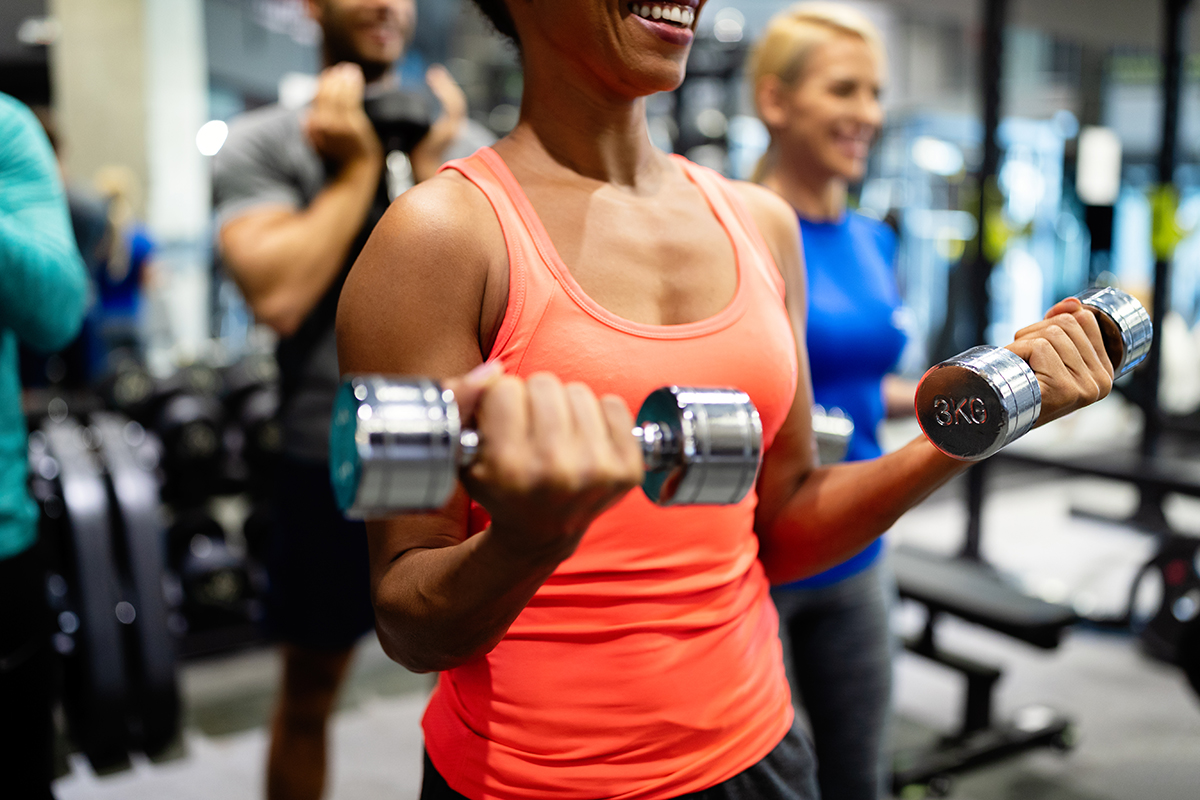 woman lifting weights in gym